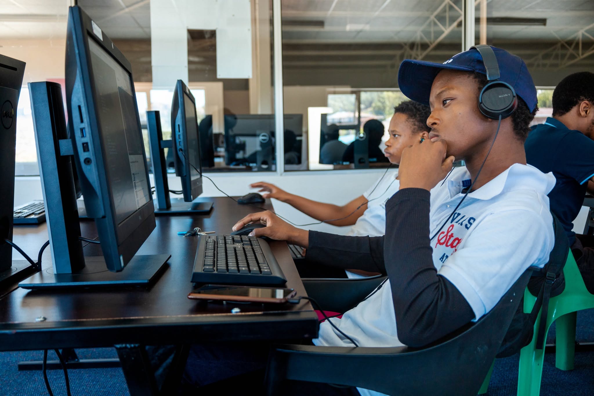 Student coding at computer workstation
